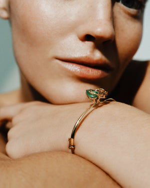 <p>frond crossover cuff bracelet</p><span>antique topaz + emerald</span><span>circa 1920 + 1930</span>