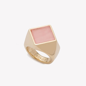 A gold band ring with a square inset of pink rhodonite.